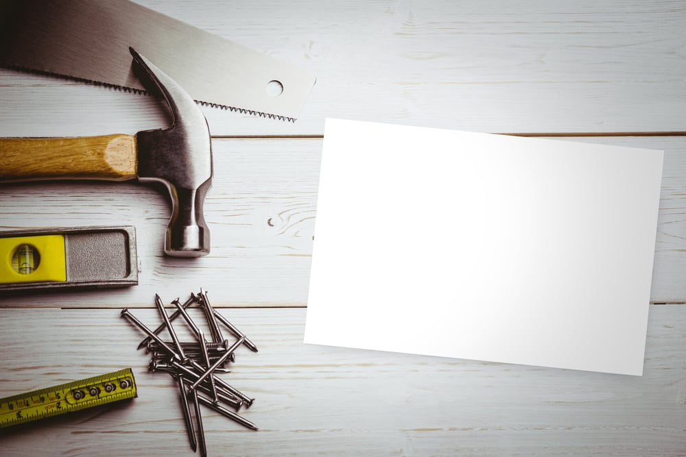 White card against desk with tools